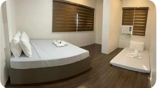 ein Schlafzimmer mit einem Bett mit zwei Waagen darauf in der Unterkunft Stay Inn Apartelle in Roxas City