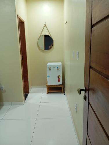 a room with a door and a mirror on the wall at Hostel dos amigos in Salinópolis