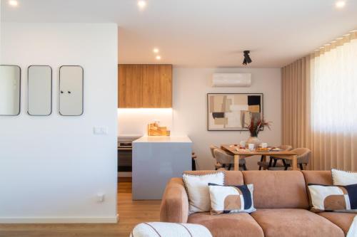a living room with a couch and a table at Stylish 2BR in Leça with AC by LovelyStay in Leça da Palmeira