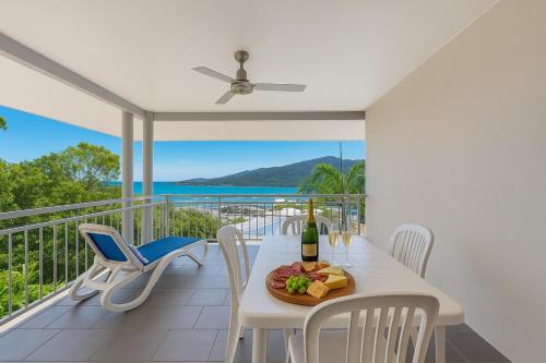 a dining room with a table with a plate of food at Amalfi Whitsunday Retreat Infinity Pool SeaViews in Airlie Beach