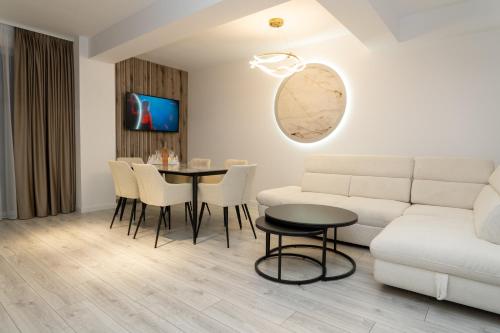 a living room with a couch and a table at GM Residence Deluxe 1&2 bedrooms in Suceava