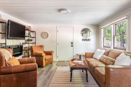 a living room with two couches and a tv at Uptown 1 Bedroom Flat Near the Boise Train Depot in Boise