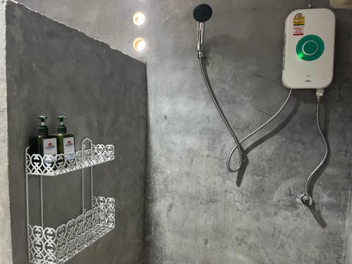 a bathroom with a shower with a soap dispenser at Phulanta Resort in Ko Lanta Yai