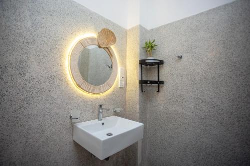 a bathroom with a sink and a mirror at The Mud Crab 80 in Ahangama