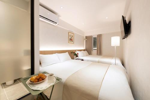 Ένα ή περισσότερα κρεβάτια σε δωμάτιο στο Hanadays Jongno-Gwanghwamun