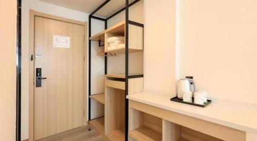 a kitchen with a counter with a coffee maker on it at Vatica Hotel Huangshan South Gate Terminal Station in Huangshan Scenic Area