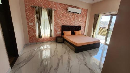a bedroom with a bed and a marble floor at 9 BHK Skyview Villa Udaipur with 2 private pool in Udaipur