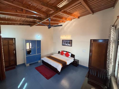 a bedroom with a bed with red pillows at Hotel Goludev Valley View in Nainital