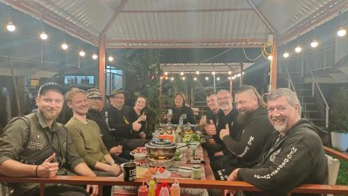 a group of people sitting at a table at Carambola Lodge in Phong Nha