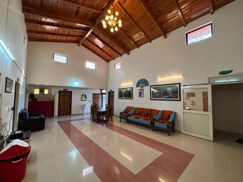 a living room with a couch and a table at Hotel Goludev Valley View in Nainital