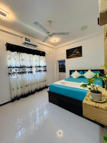 a bedroom with a bed and a window with curtains at Nisha Grean Heaven in Weligama