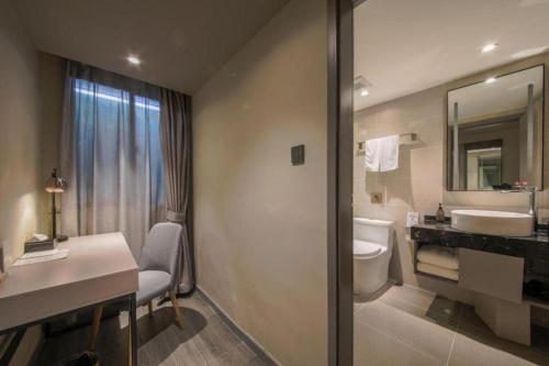 a bathroom with a sink and a toilet at City Comfort Inn Hotel Wuhan Optics Valley Square Metro Station Zhongnan Minzu University in Wuhan