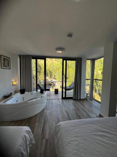 a large bathroom with a tub and a bed at Xaxa Lodge in Tarma