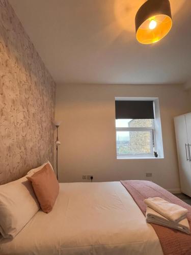 a bedroom with a white bed and a window at TLK Apartments & Hotel - Beckenham Junction in London