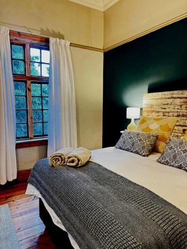 a bedroom with a bed with two towels on it at Splash 9 in Trompsburg
