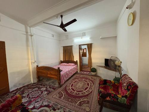 a bedroom with a bed and a ceiling fan at The Indoor Retreat in Siliguri