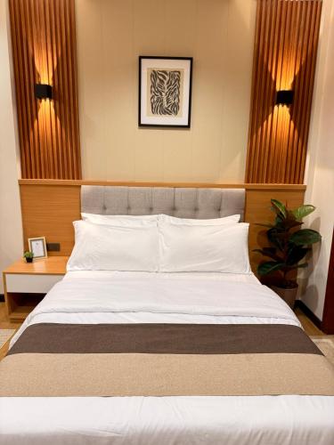 a bedroom with a large white bed in a room at Lafontana Hometel in Roxas City