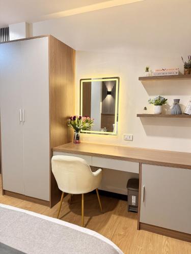 a bedroom with a desk with a chair and a mirror at Lafontana Hometel in Roxas City