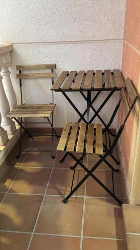a bench and a table in a room at Beach Apartament Playa in El Campello