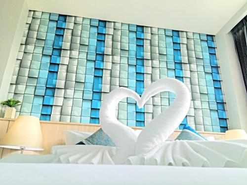 two white swans making a heart in a bedroom at The Wings Boutique Hotels Krabi Koh Lanta in Ko Lanta