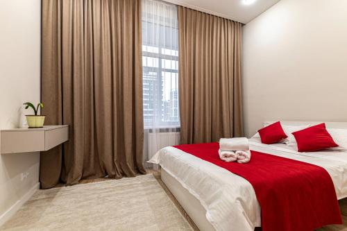 Postel nebo postele na pokoji v ubytování Уютная евродвушка возле Астана Арены