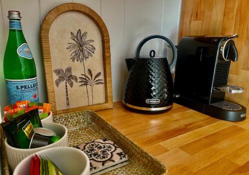 a kitchen counter with a coffee maker and a toaster at Jasmine Hideaway Guesthouse Near SCUH Hospital in Kawana Waters