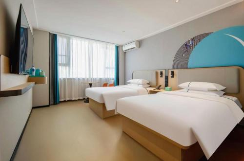 Ένα ή περισσότερα κρεβάτια σε δωμάτιο στο City Comfort Inn Nanning Guangxi University