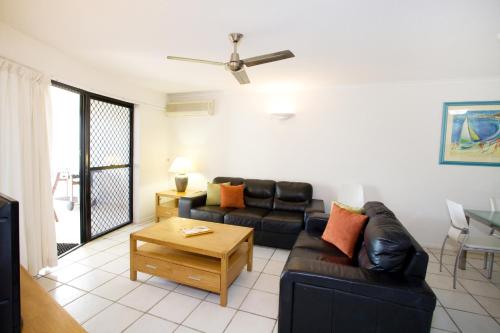 a living room with a couch and a table at Spinnaker Quays in Mooloolaba