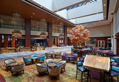 a lobby with chairs and tables and a bar at Concorde Hotel Kuala Lumpur in Kuala Lumpur