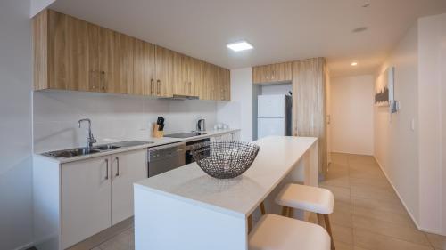 a kitchen with a sink and a refrigerator at Annexe Apartments in Brisbane