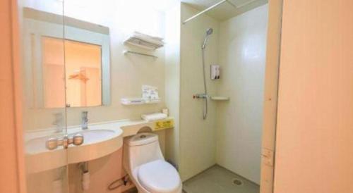 a bathroom with a toilet and a sink and a shower at 7 Days Inn·Ulanqab Tsining railway station in Jining