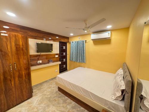 a bedroom with a bed and a tv in it at Velora Stays in Kolkata