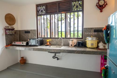 a kitchen counter with a sink and a window at Villa Sky View Hikka in Hikkaduwa