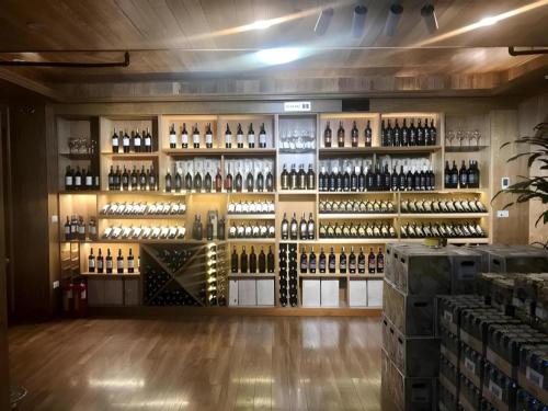 a room filled with lots of bottles of wine at Lenid Hotel Tho Nhuom in Hanoi