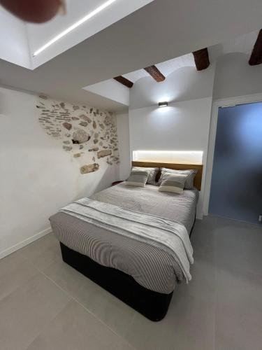 a bedroom with a large bed and a tv at Les Cases de Laia in Bocairent
