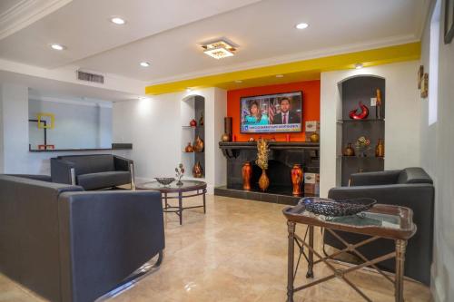a living room with two chairs and a tv at Rodeway Inn Near Ybor City - Casino in Tampa