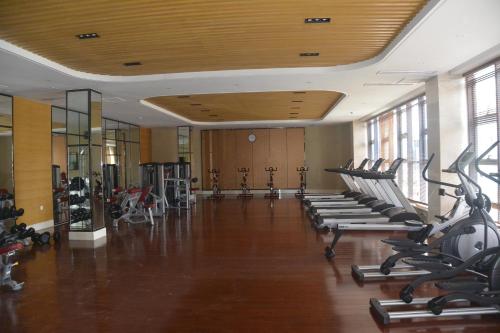 a gym with rows of treadmills and elliptical machines at Hotel Anda China Malabo in Malabo