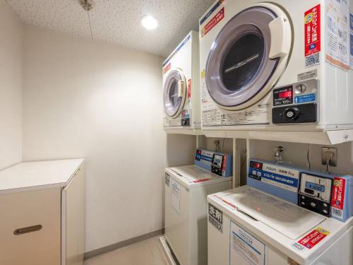 a laundry room with a washing machine and a washer and dryer at Comfort Inn Fukui in Fukui