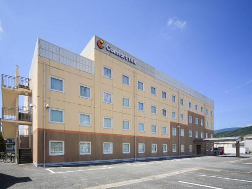 a large building with a parking lot in front of it at Comfort Inn Tosu in Tosu