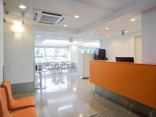 an office with a reception desk and tables and chairs at Comfort Inn Tosu in Tosu