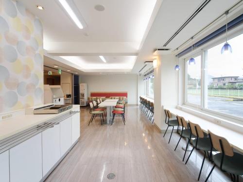 a kitchen and dining room with a table and chairs at Comfort Inn Tosu in Tosu