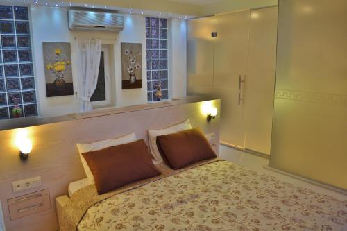 a bedroom with a large bed with two pillows at Villa Mercan in Kalkan