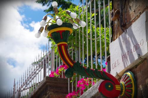 a street light on the side of a fence with flowers at Casalbergo in Siena