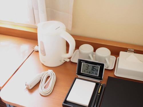 a counter with a coffee maker and a scale on a table at Comfort Inn Kumamoto Miyukifueda in Kumamoto