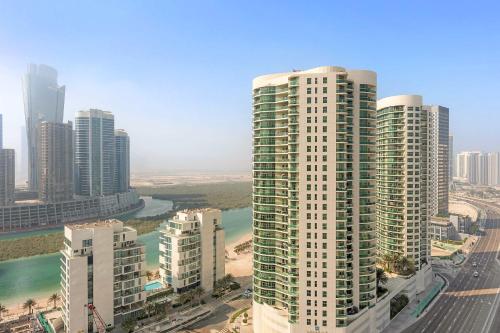 an aerial view of a city with tall buildings at Silkhaus 1BDR Serene Stay in Reem Island in Mushayrib