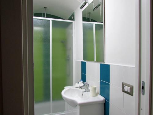 La salle de bains est pourvue d'un lavabo et d'une douche. dans l'établissement Flora, à Atrani