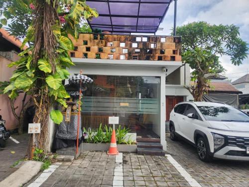 a white car parked in front of a house at Nana's Villa Sanur in Sanur