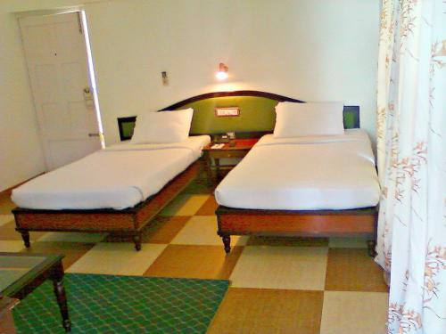 Postel nebo postele na pokoji v ubytování Kappad Beach Resort