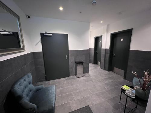 a waiting room with three doors and a table at Hotel Falken in Hechingen