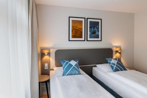 Ένα ή περισσότερα κρεβάτια σε δωμάτιο στο GHOTEL hotel & living Hannover